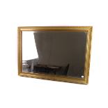 A gilt and anodised metal framed bevel edged mirror, 72.5cm x 102.5cm, plus one other