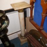 An onyx column,  with brass capitals and on brass feet