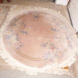 A modern Chinese circular rug,  thick pile, with dusty pink field and floral designs, 66cm diameter,