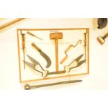 A collection antique and vintage thatcher's tools, mounted on a board, having sheers, a mallet and