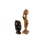A collection of African tribal art,  including a carved wooden tortoise, ebony masks, utensils,
