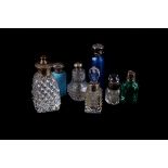 A group of early 20th century silver capped or collared scent bottles,  various designs, including a