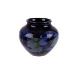A 20th century Moorcroft 'Pansy' vase, of squat circular design, with impressed factory mark and