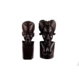 A pair of African carved ebony tribal busts, in the male and female form 22cm H, and smaller