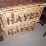 A pair of 20th century Hayes wicker laundry hampers,  with leather straps (2)