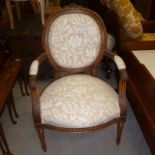 A beech framed French style cameo back arm chair,  upholstered in cream and beige brocade