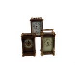 Three antique and vintage brass carriage timepieces, each with arch lever escapement movement, one