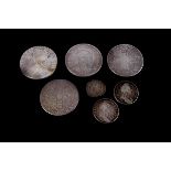 A group of seven 16th to 18th century coins, including an Elizabeth I hammered half groat, two