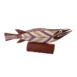 An Aboriginal fish carving, decorated in sienna, and white pigments to an umber ground 42cm L