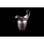 A late Georgian Newcastle silver baluster cream jug by Thomas Wheatley, the body engraved with