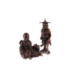 An early 20th century Chinese hardwood figure of an immortal, in coolie hat and carrying beads, plus