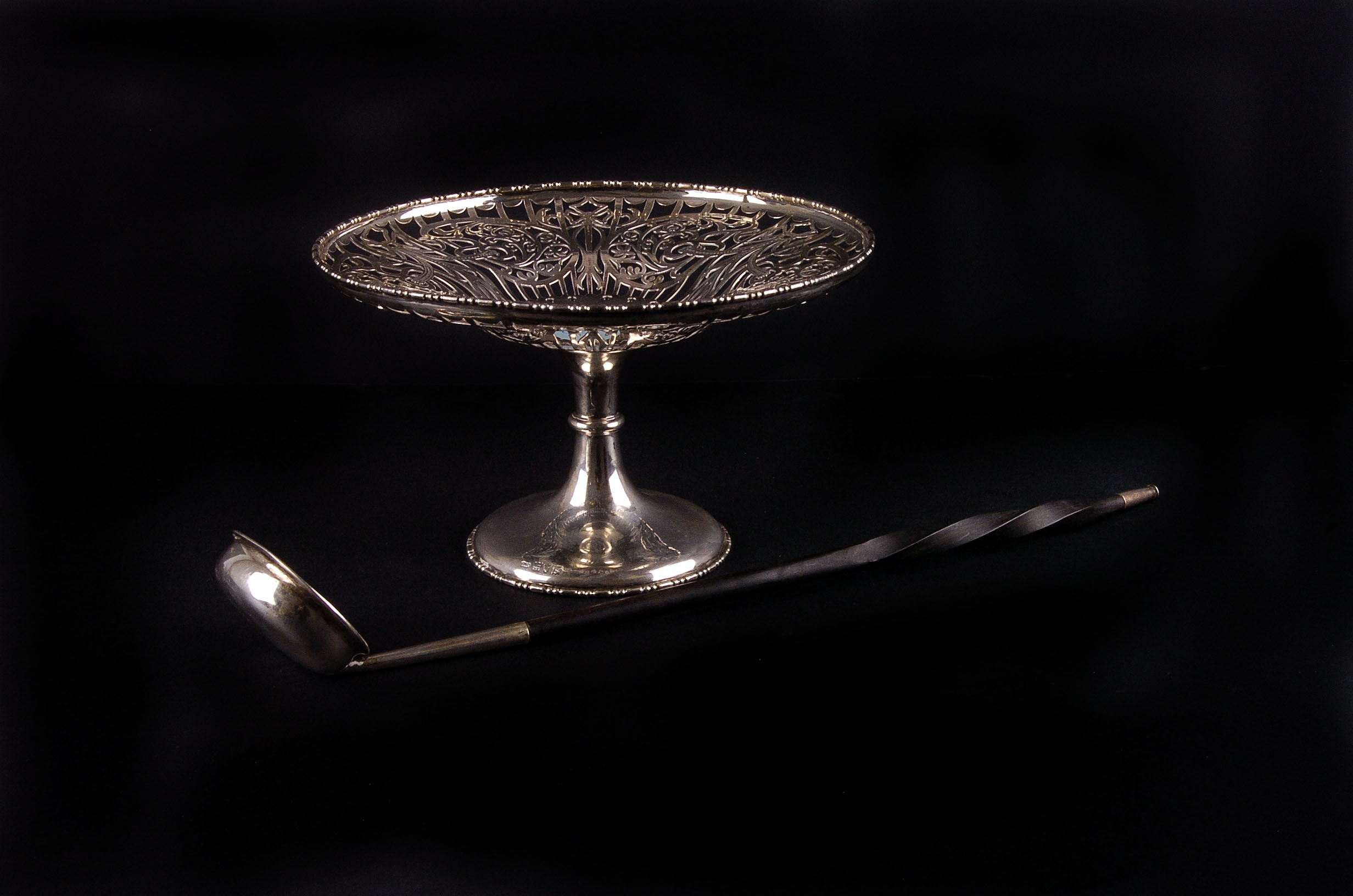 A George V reticulated silver tazza, London 1913 by Carrington & Co., plus a baleen handled punch