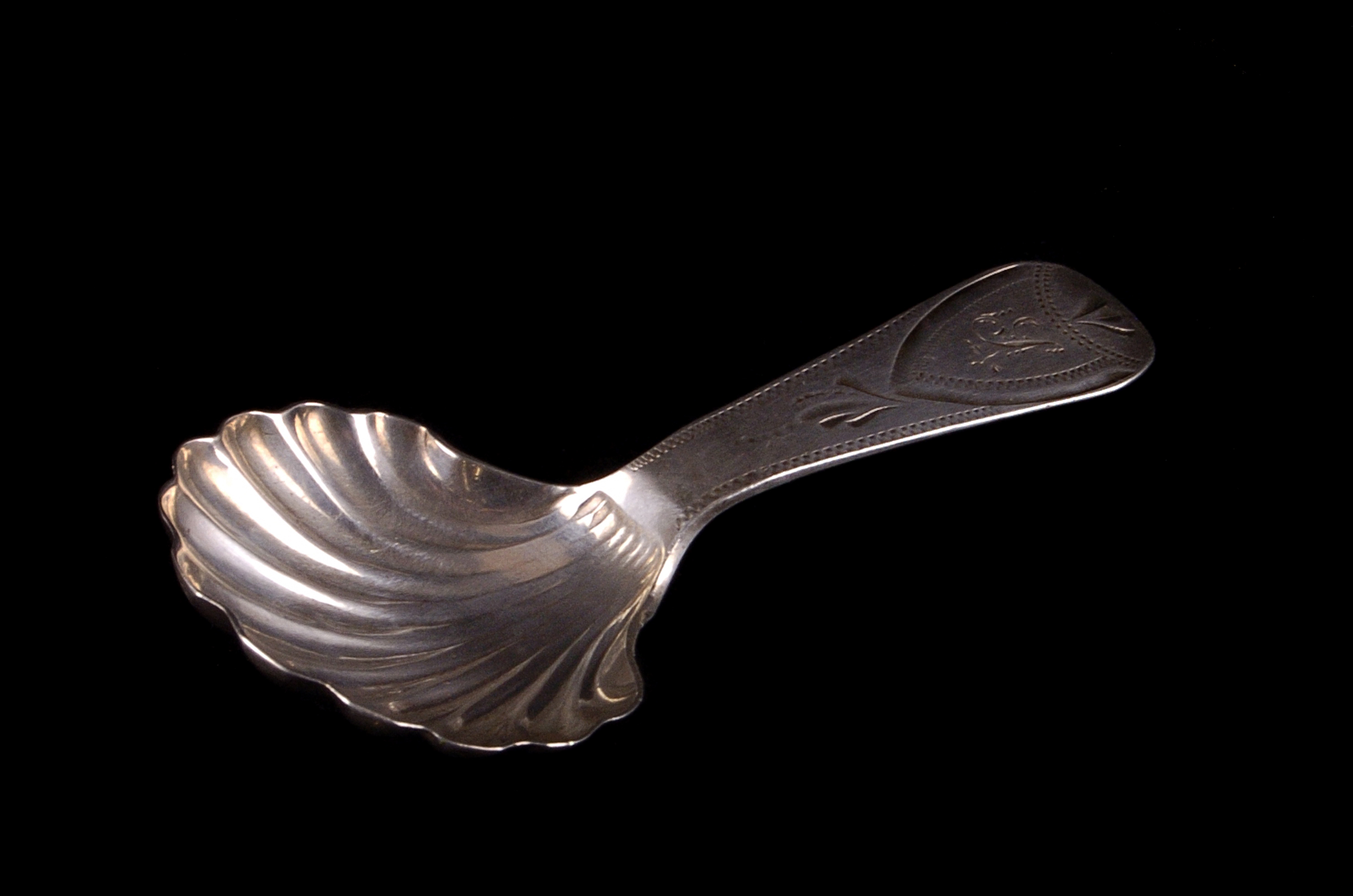 A late Georgian Newcastle silver caddy spoon by Thomas Wheatley, bright cut engraved, with a shell