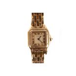 Cartier Santos, a lady’s 18ct gold quartz wristwatch, with champagne dial, black Roman numerals,