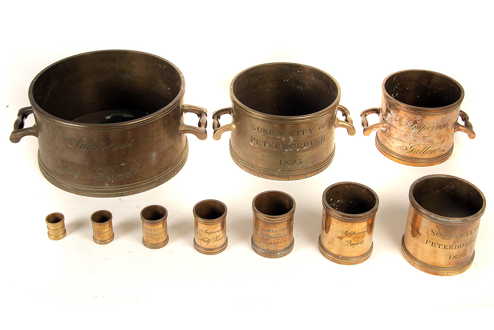 A fine and rare part-set of early 19th Century brass Imperial Dry and Liquid Measures for City and