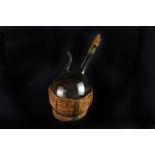 An Italian green glass wine decanter with ice reservoir,  with raffia sleeve and cork, 37cm high,