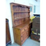 A late 20th century elm bespoke kitchen dresser, the plate rack surmounting a three door base on