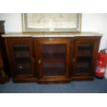 A Victorian rosewood break front book case cabinet, with marble top over three door, on plinth base,