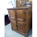 A Victorian oak pantry cabinet, with panelled top and doors, and with heavy brass catches and hinges