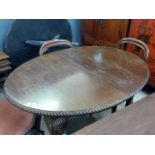 An early 20th century mahogany wind-out oval dining table, with gadrooned edge over cabriole legs