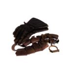 A vintage pair of handcuffs, together with a large pair of leather glove and a belt with multiple