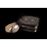 An Edwardian long bristle brush,  embossed with a ship design, together with a silver plated