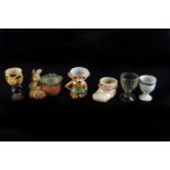 A collection of glass, ceramic and wooden egg cups,  various designs and makers (parcel)