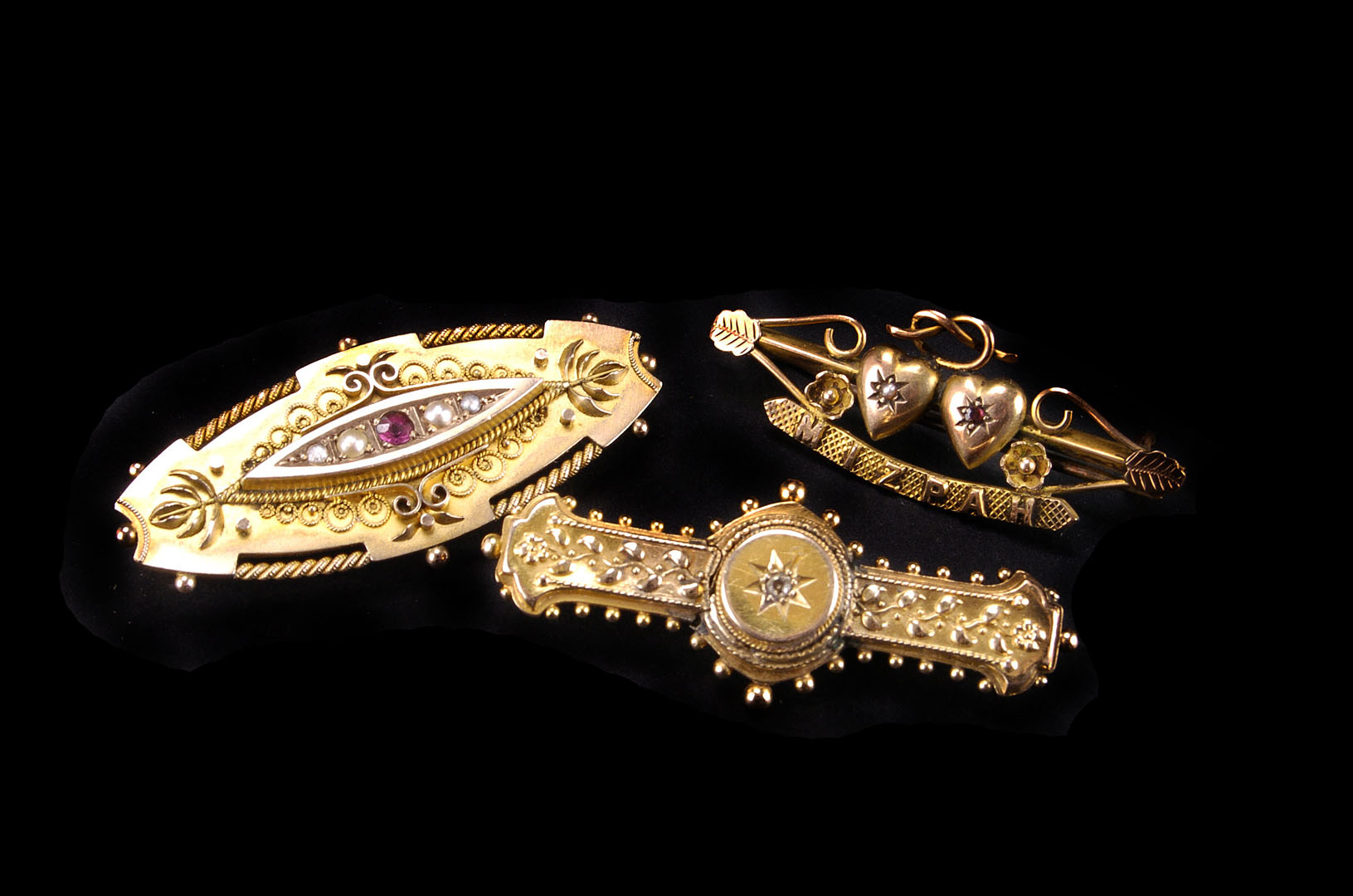 A group of five gold and yellow metal brooches,  including a Victorian 15ct and a 9ct example, a