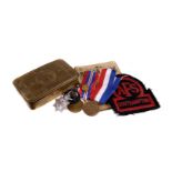 A selection of various military items, to include a 1914 Christmas tin, various badges and medals,