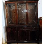 A modern reproduction mahogany bookcase cabinet, the base with three drawers and doors below three