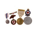 A WWI British Red Cross Medal,  together with three Red Cross enamel badges, a medallion and a