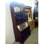 A George III mahogany bureau bookcase, the later astrigally glazed top surmounts and Cuban