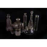 A group of late Victorian and Edwardian silver capped dressing table jars,  of various designs,