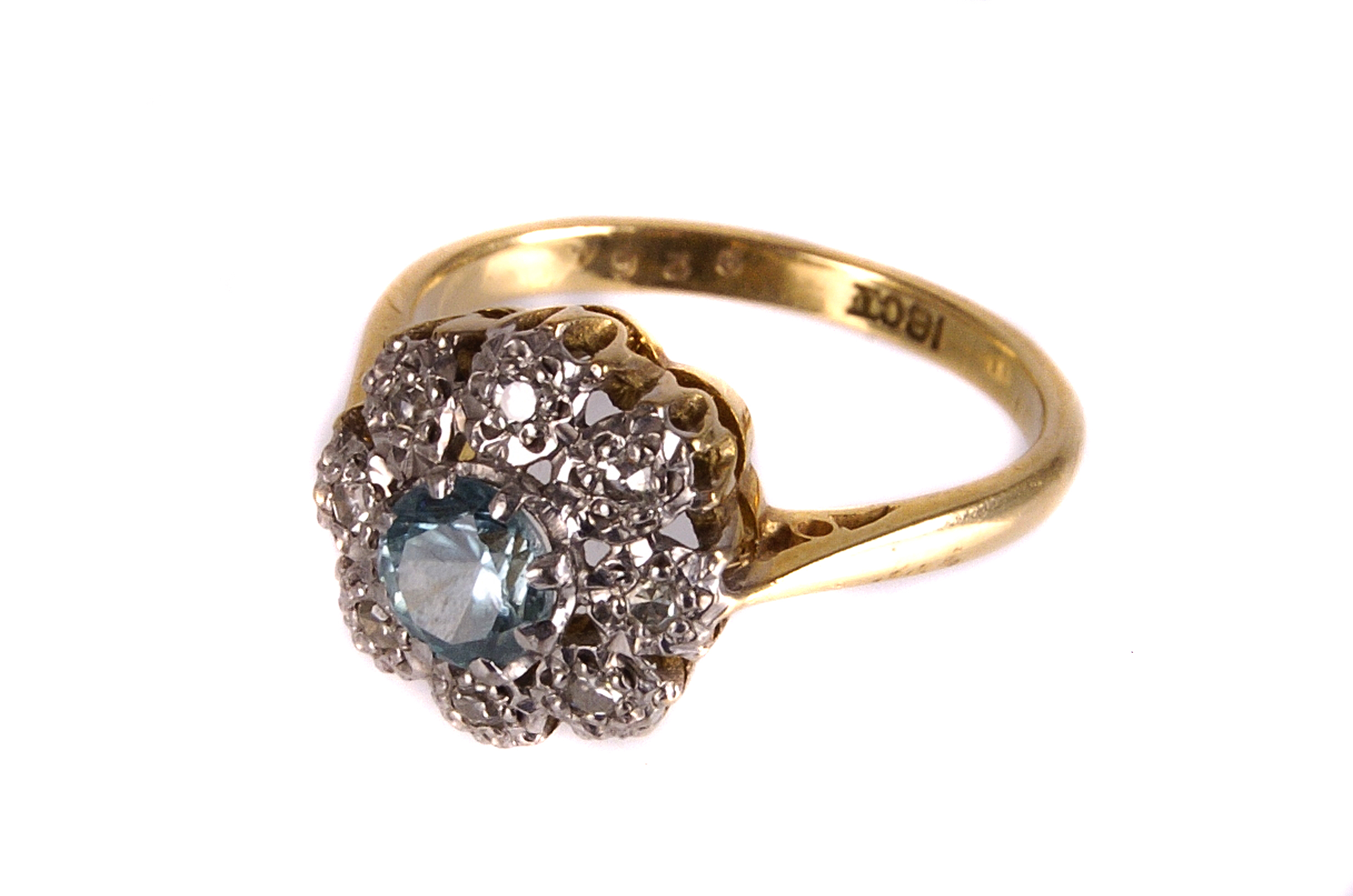 A modern 18ct gold and gem set cluster dress ring, with a central light blue stone, probably a