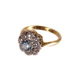 A modern 18ct gold and gem set cluster dress ring, with a central light blue stone, probably a