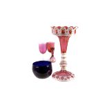 A 19th century white enamel cut to cranberry Bohemian lustre candlestick,  missing lustres, 32cm