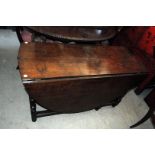 A 19th century oak drop leaf gate leg table