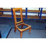 A 19th century sycamore bedroom chair, with barley twist legs and back supports, on brass castors,