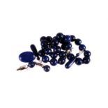A group of lapis jewellery,  including a bead necklace, drop earrings, an oval brooch, and a pair of