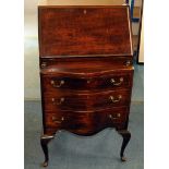 A vintage mahogany bureau, on cabriole supports with three drawers below folding writing panel to
