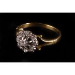 An 18ct gold and diamond cluster ring, having split shoulders and round cluster with raised