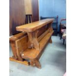 A pair of late 20th century bespoke elm benches, with trestle board ends and pegged bar stretcher