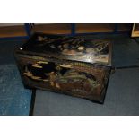 An Art Deco period Japanese lacquered blanket chest, having black ground with carved scenes to