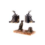A pair of Art Deco black marble bookends,  with leaping ibex, together with a marble pen tidy,