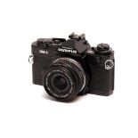 An Olympus OM-4 SLR Camera, black, with Olympus Auto-W f/2.8 24mm lens