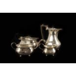 An Edwardian four piece silver tea set, three pieces marked London 1902, one Sheffield 1903, all