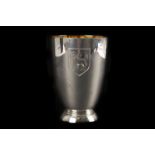 A modern silver beaker, the tapered form having engraved shield, on spreading foot with gilt well