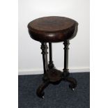 A Victorian walnut and inlaid work table, the circular box top with interior lacking, on three
