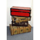 A group of four vintage travel trunks and cases, one canvas and wooden strut example with various