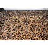 A modern woollen carpet, in beige and light green, with scrolling foliage, machine knotted,